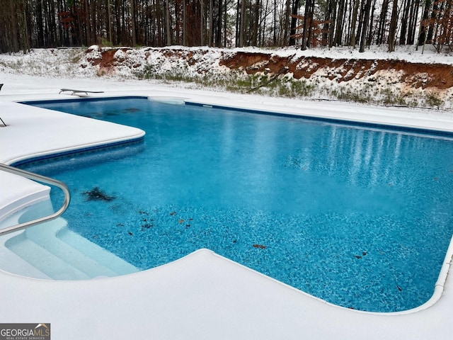 snow covered pool with a diving board