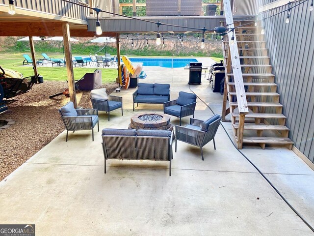 view of patio / terrace with an outdoor living space with a fire pit