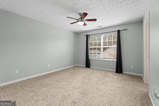 carpeted empty room with a textured ceiling and ceiling fan