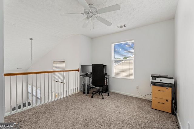 office featuring ceiling fan, carpet flooring, vaulted ceiling, and a textured ceiling