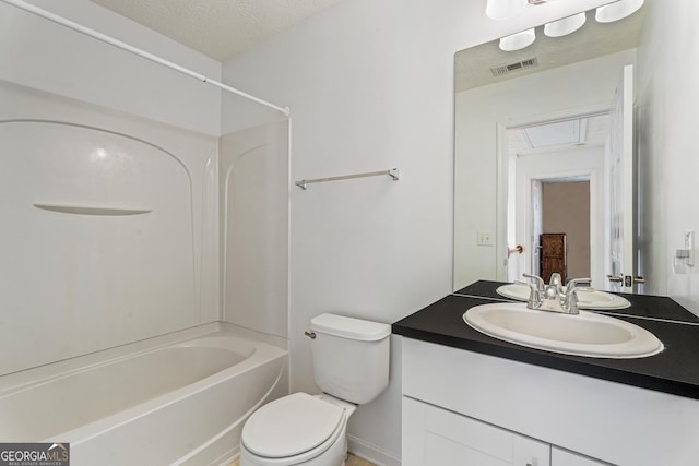 full bathroom featuring vanity, toilet, a textured ceiling, and  shower combination