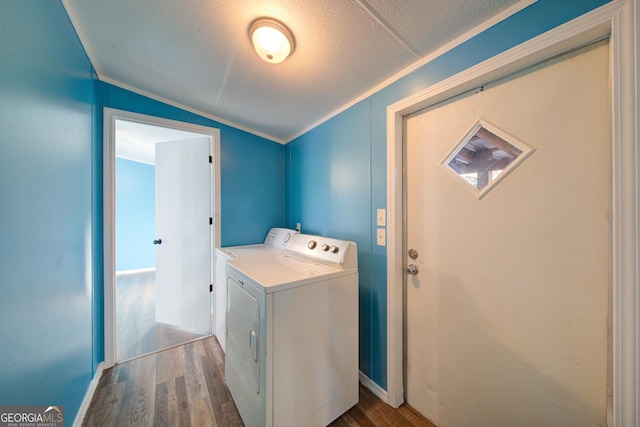 laundry area featuring washer / clothes dryer, hardwood / wood-style flooring, and a textured ceiling