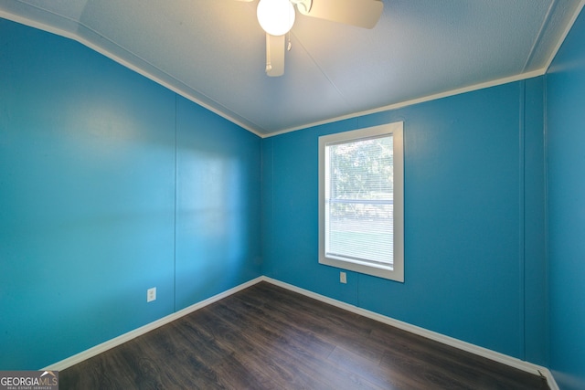 unfurnished room featuring ornamental molding, vaulted ceiling, dark hardwood / wood-style floors, and ceiling fan