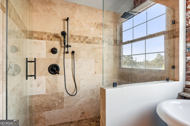 full bathroom featuring a sink and a tile shower