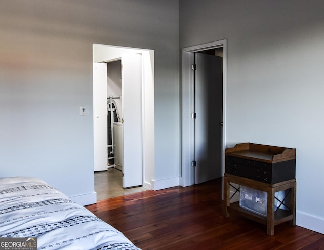 bedroom with baseboards and wood finished floors