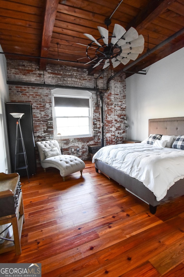 bedroom with wood ceiling, brick wall, wood-type flooring, and beamed ceiling