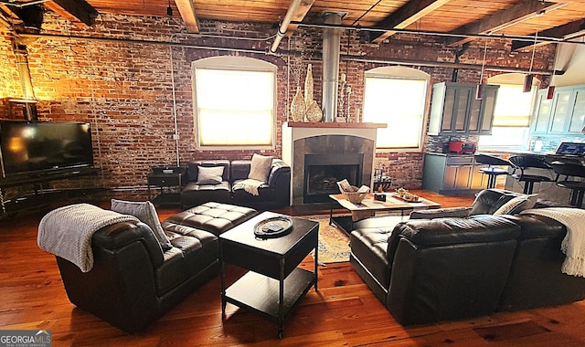 living room with brick wall, hardwood / wood-style floors, beamed ceiling, and wood ceiling