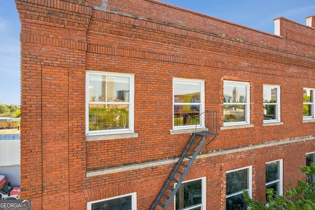 view of side of home with brick siding