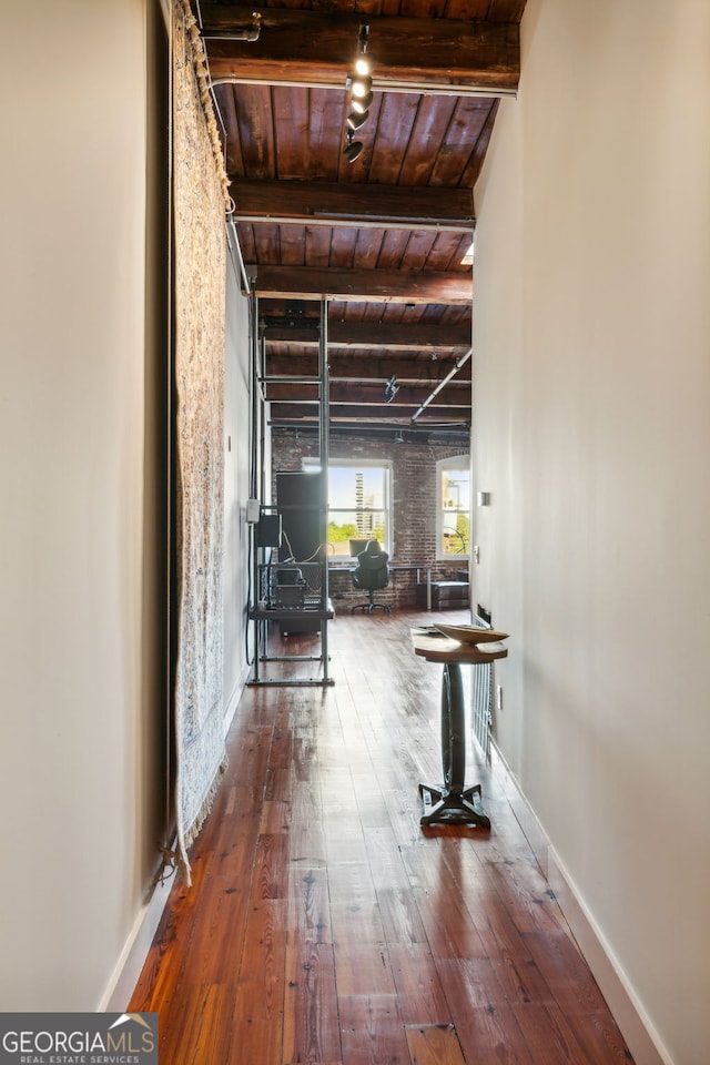 corridor with hardwood / wood-style floors, beamed ceiling, wood ceiling, and baseboards