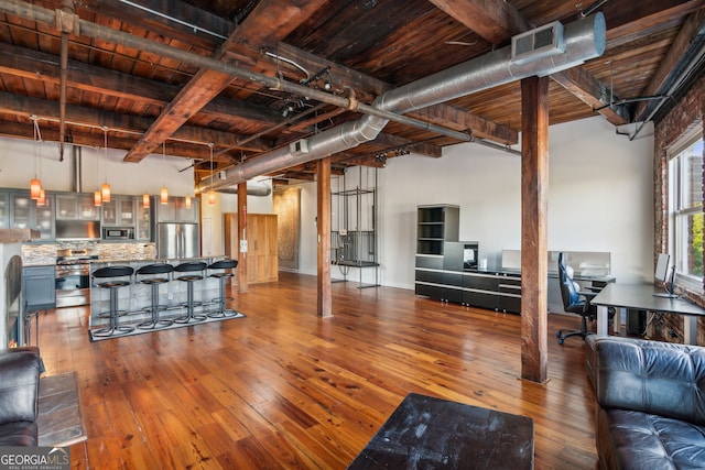 living area with hardwood / wood-style flooring, wood ceiling, visible vents, and beam ceiling