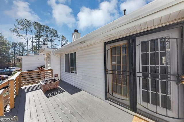 deck with an outdoor fire pit