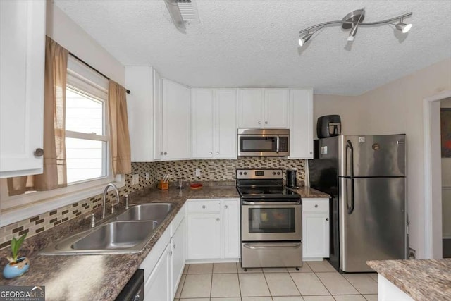 kitchen featuring appliances with stainless steel finishes, sink, and white cabinets