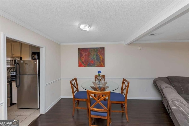 dining room featuring crown molding, hardwood / wood-style floors, and a textured ceiling