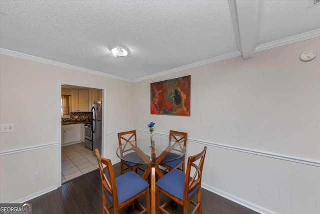 dining room featuring ornamental molding, dark hardwood / wood-style flooring, and a textured ceiling