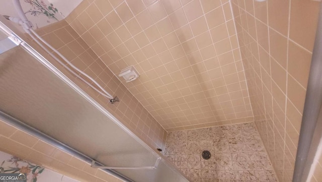 bathroom with a tile shower