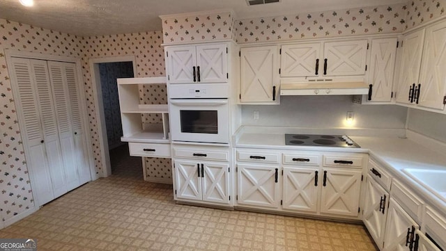 kitchen featuring oven and black electric cooktop