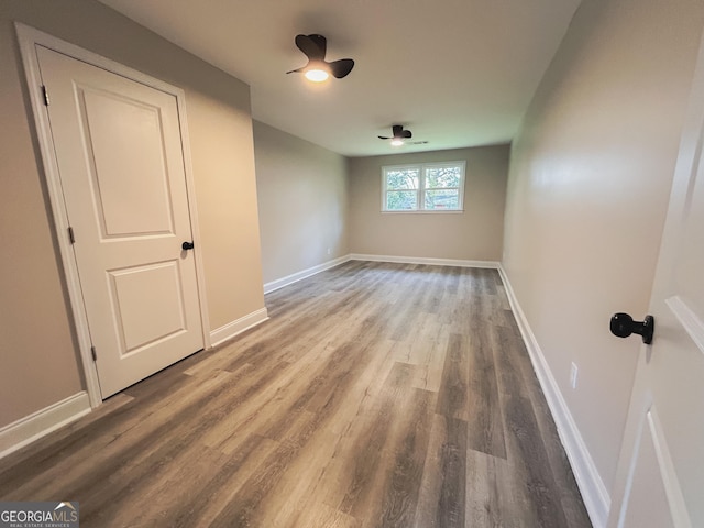 empty room featuring ceiling fan and hardwood / wood-style floors