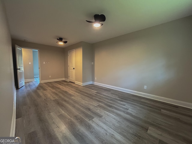 unfurnished room featuring dark wood-type flooring