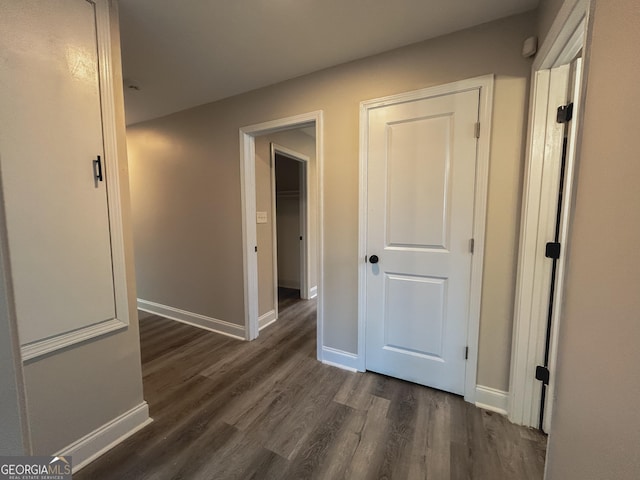 hall with dark wood-type flooring