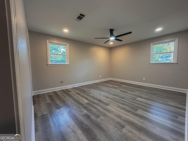 spare room featuring dark hardwood / wood-style flooring, plenty of natural light, and ceiling fan