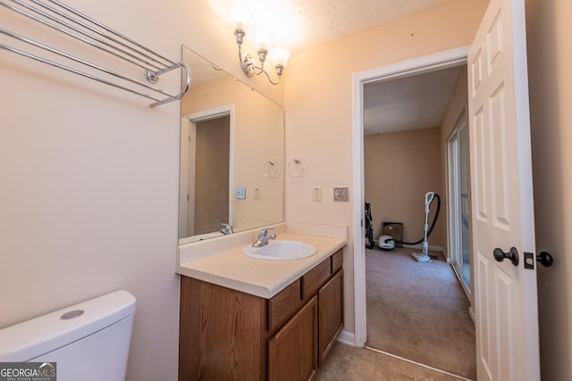 bathroom with vanity, tile patterned floors, and toilet