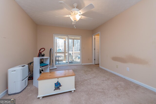 miscellaneous room featuring ceiling fan and light colored carpet