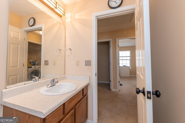 bathroom with vanity and washer / clothes dryer