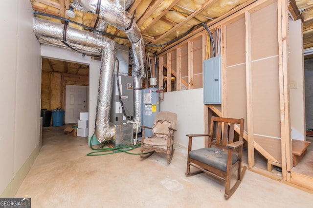 basement featuring electric panel and electric water heater