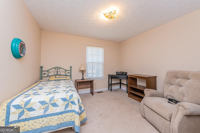 carpeted bedroom featuring a textured ceiling