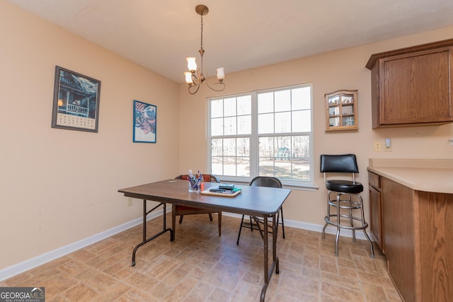 dining area featuring a notable chandelier