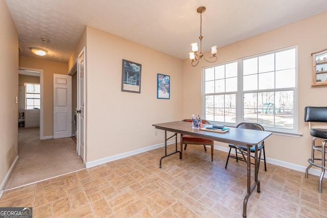 office area with a notable chandelier and a textured ceiling