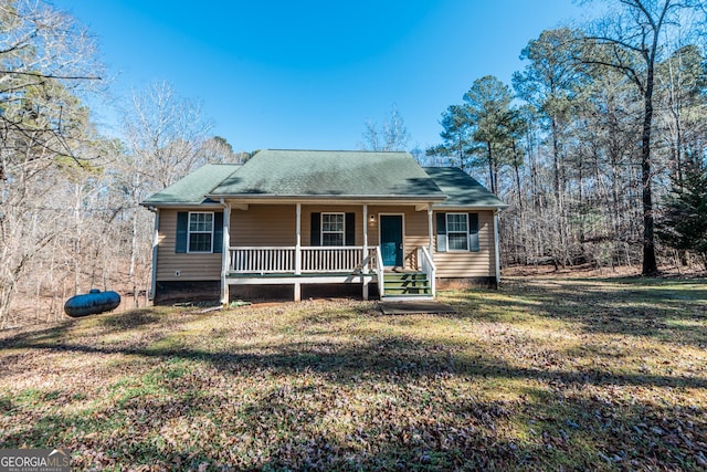 view of front of home featuring covered porch and a front yard