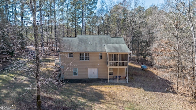 rear view of house with a sunroom and a patio area