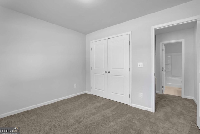 unfurnished bedroom featuring carpet and a closet