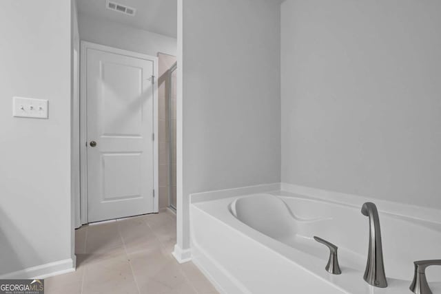 bathroom with tile patterned flooring and plus walk in shower