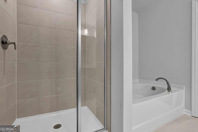 bathroom featuring shower with separate bathtub