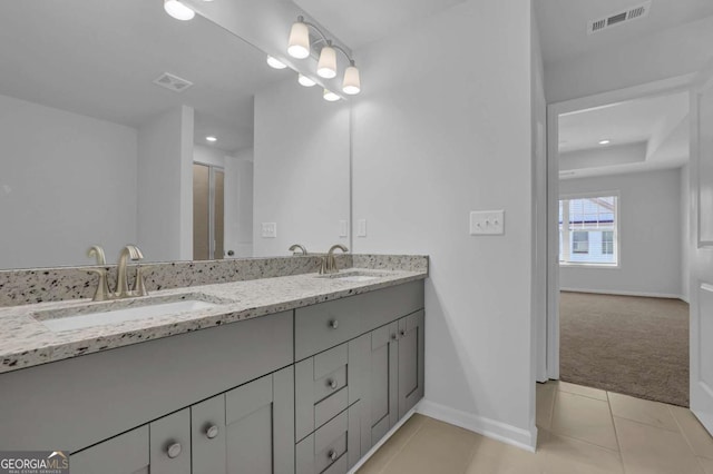 bathroom with tile patterned flooring and vanity