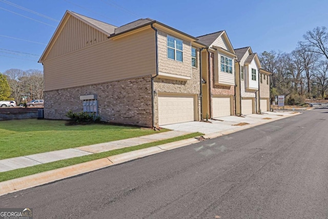 view of side of property with a garage and a lawn