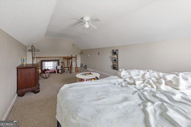 bedroom with vaulted ceiling, light carpet, and a textured ceiling