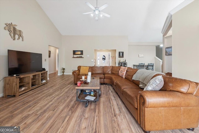 living room featuring hardwood / wood-style flooring, high vaulted ceiling, and ceiling fan