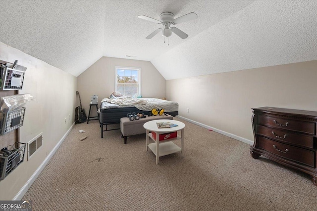 carpeted bedroom with ceiling fan, lofted ceiling, and a textured ceiling