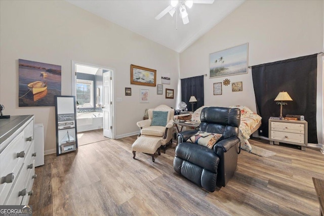 interior space featuring ceiling fan, wood-type flooring, and high vaulted ceiling