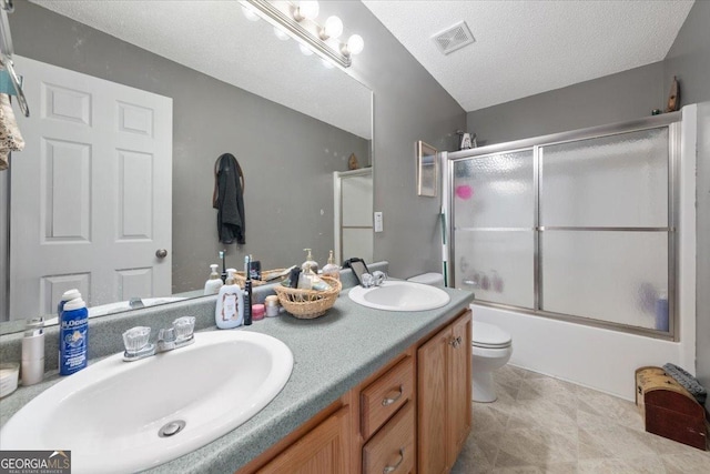 full bathroom with vanity, toilet, enclosed tub / shower combo, and a textured ceiling