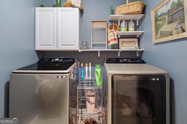 laundry room with cabinets and washing machine and clothes dryer