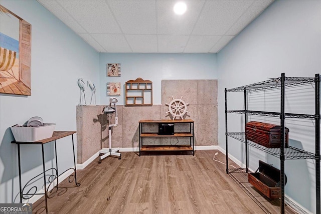 misc room featuring hardwood / wood-style flooring and a paneled ceiling