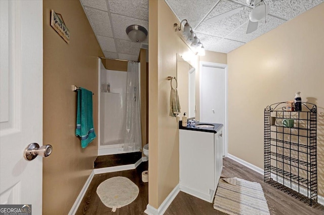 bathroom featuring hardwood / wood-style flooring, vanity, a paneled ceiling, and a shower with shower curtain