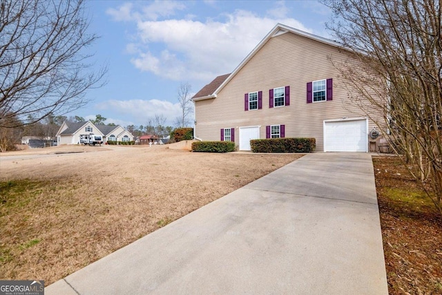 view of side of home with a garage and a yard