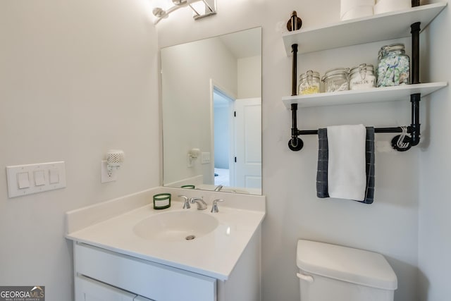 bathroom featuring vanity and toilet