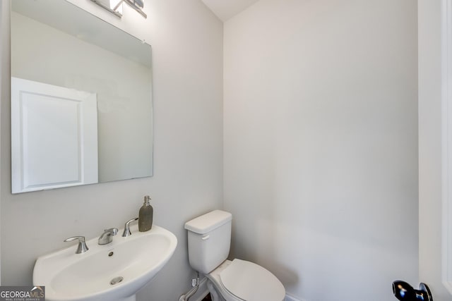 bathroom featuring toilet and sink