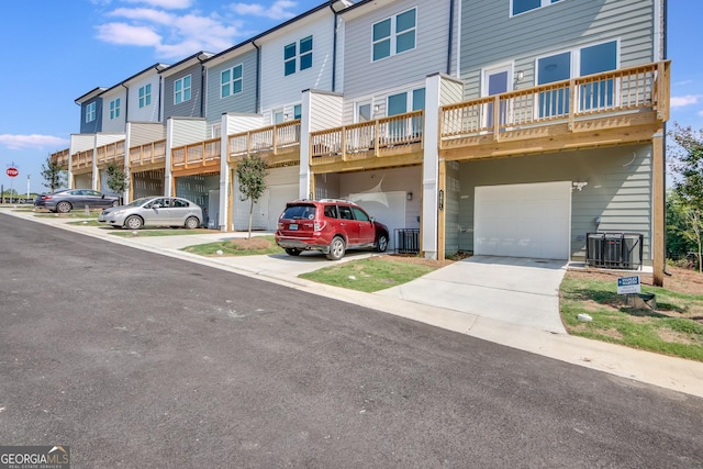 townhome / multi-family property featuring a garage and central air condition unit